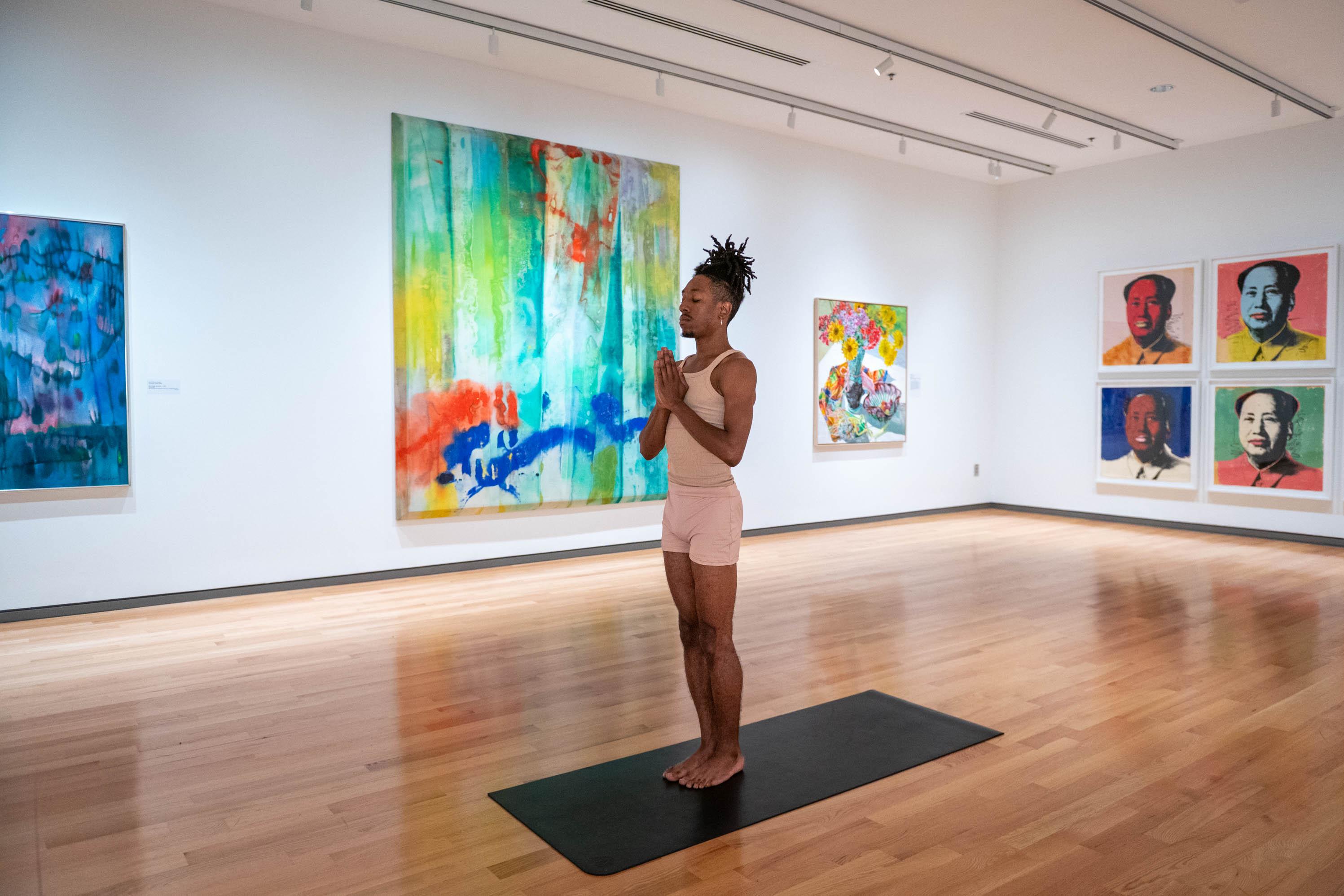 Dre Drummond in yoga pose in Gallery of colorful art 